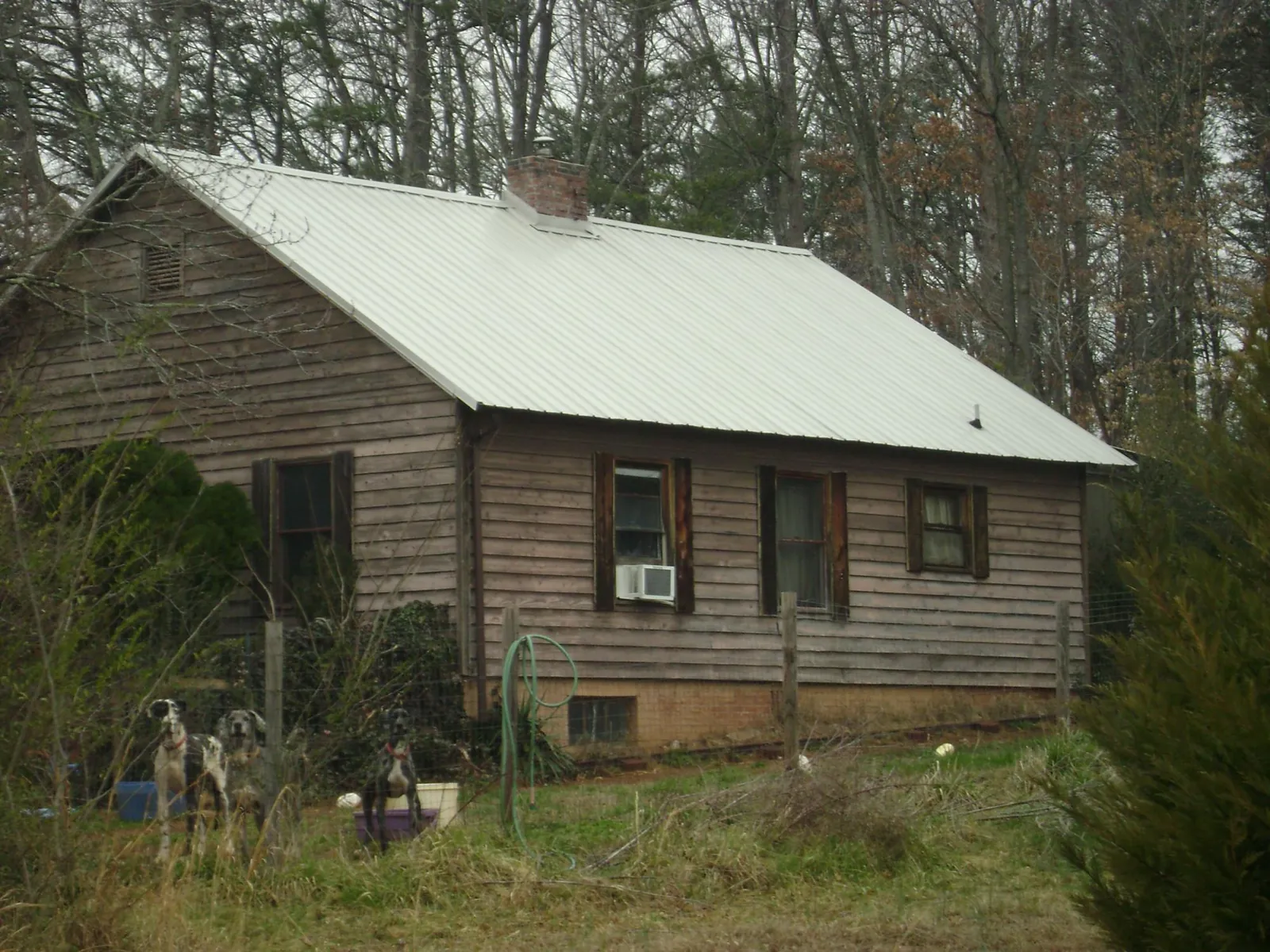 White metal roof on an old wood sided farmhouse, from a Metal Roof Installation job in Maynardville